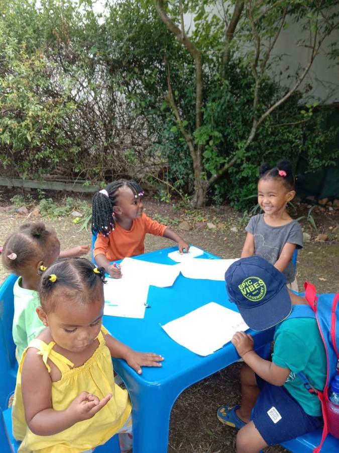 Children laughing at an outdoor table