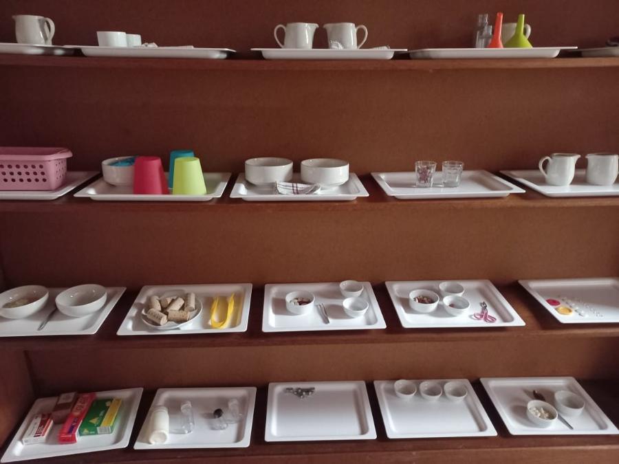 Montessori practical-life materials on shelves